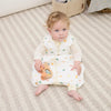 Baby wearing ClevaMama Mushroom DreamSuit playing comfortably in breathable Australian cotton