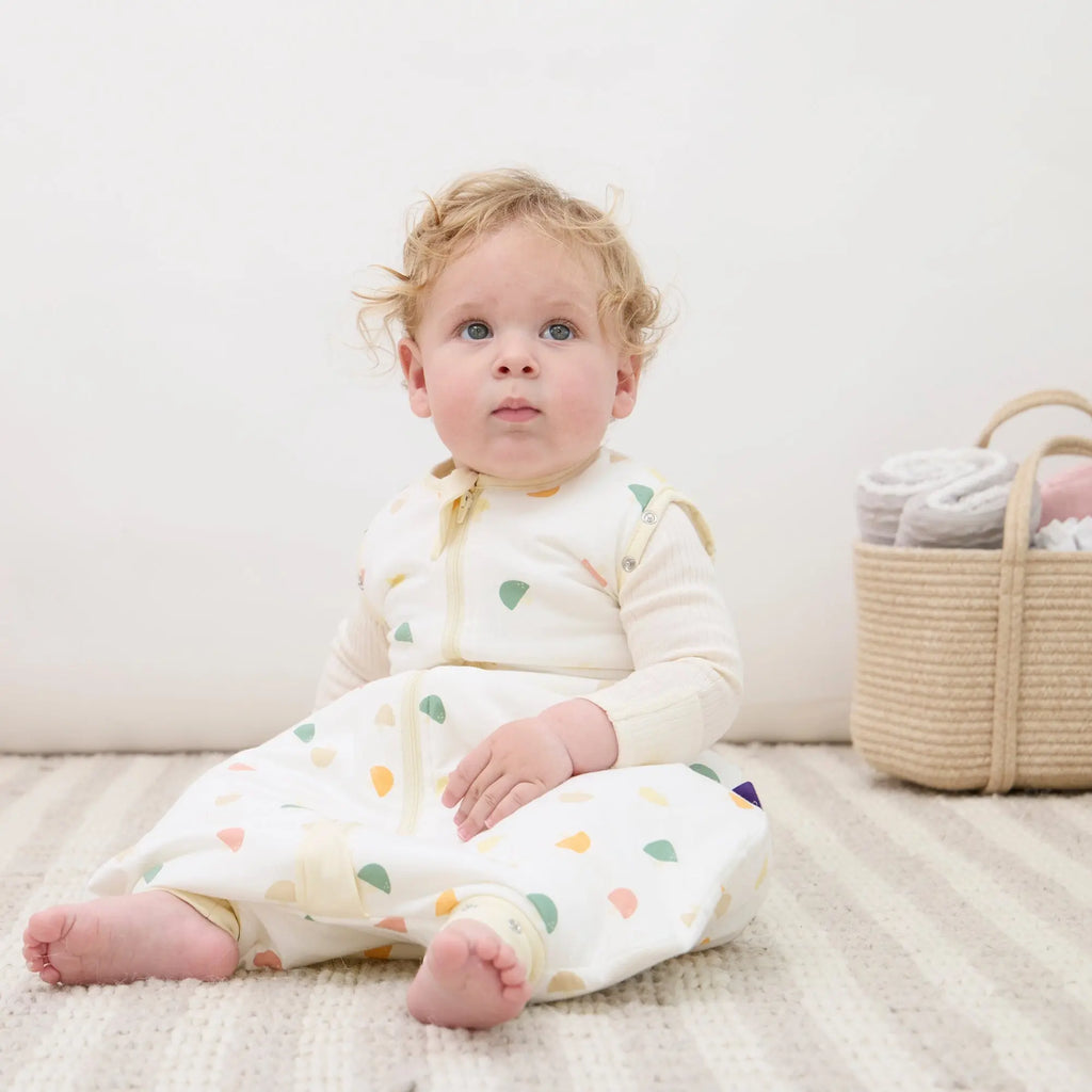Baby wearing ClevaMama Mushroom DreamSuit sitting comfortably in breathable Australian cotton